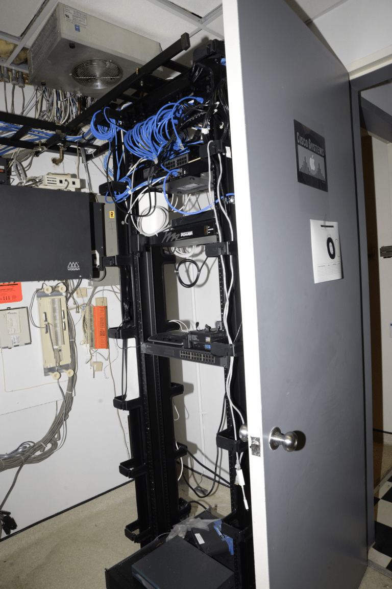 Rows of network servers with cabling in a managed IT data room